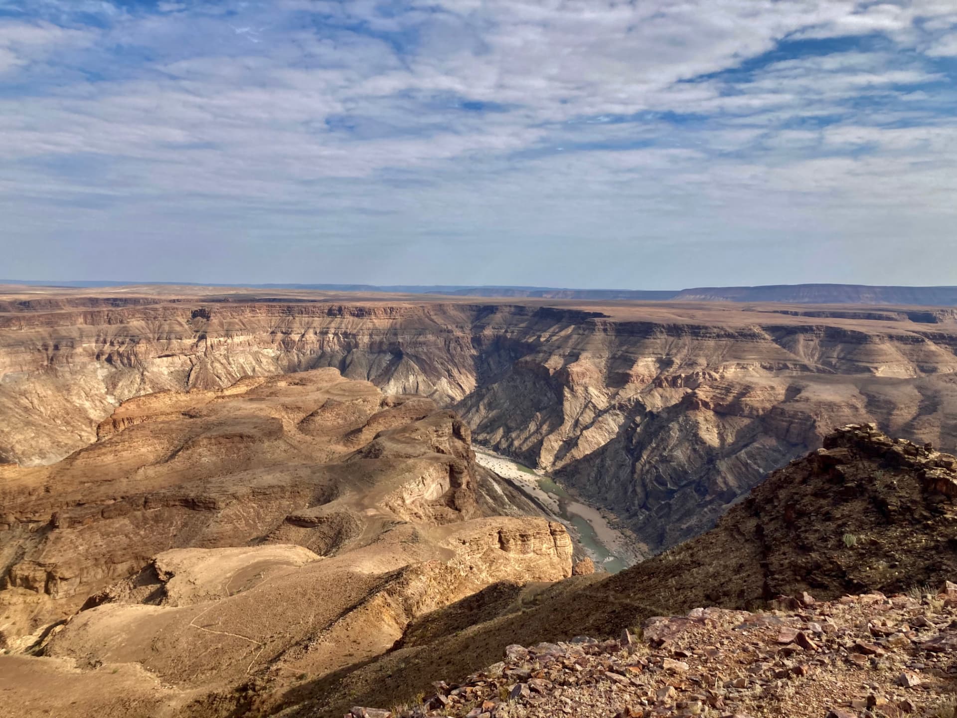 A wide view across Fish River Canyon under a bright cloud-streaked sky