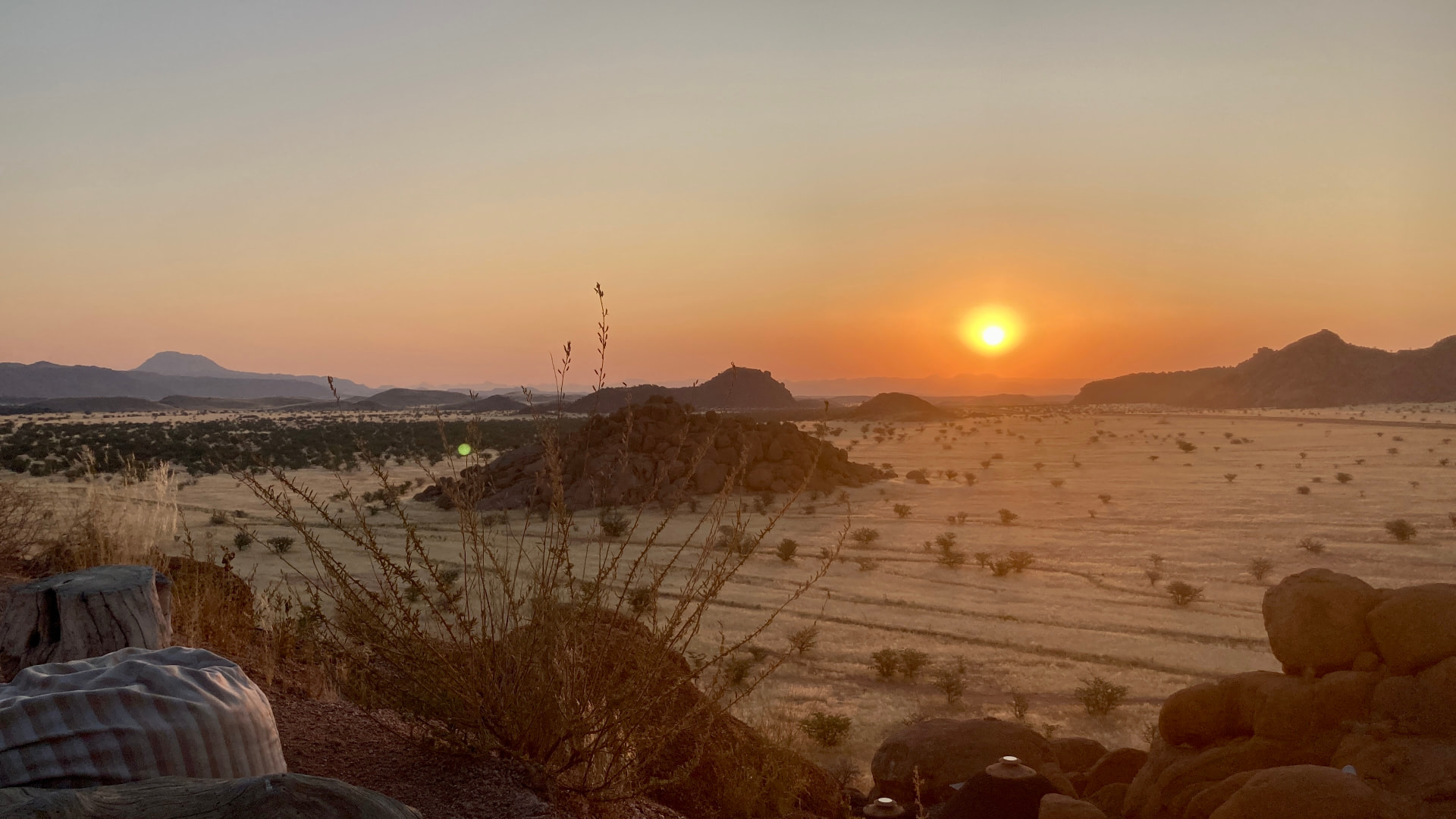 Sun setting over granite koppies and open plains in Damaraland